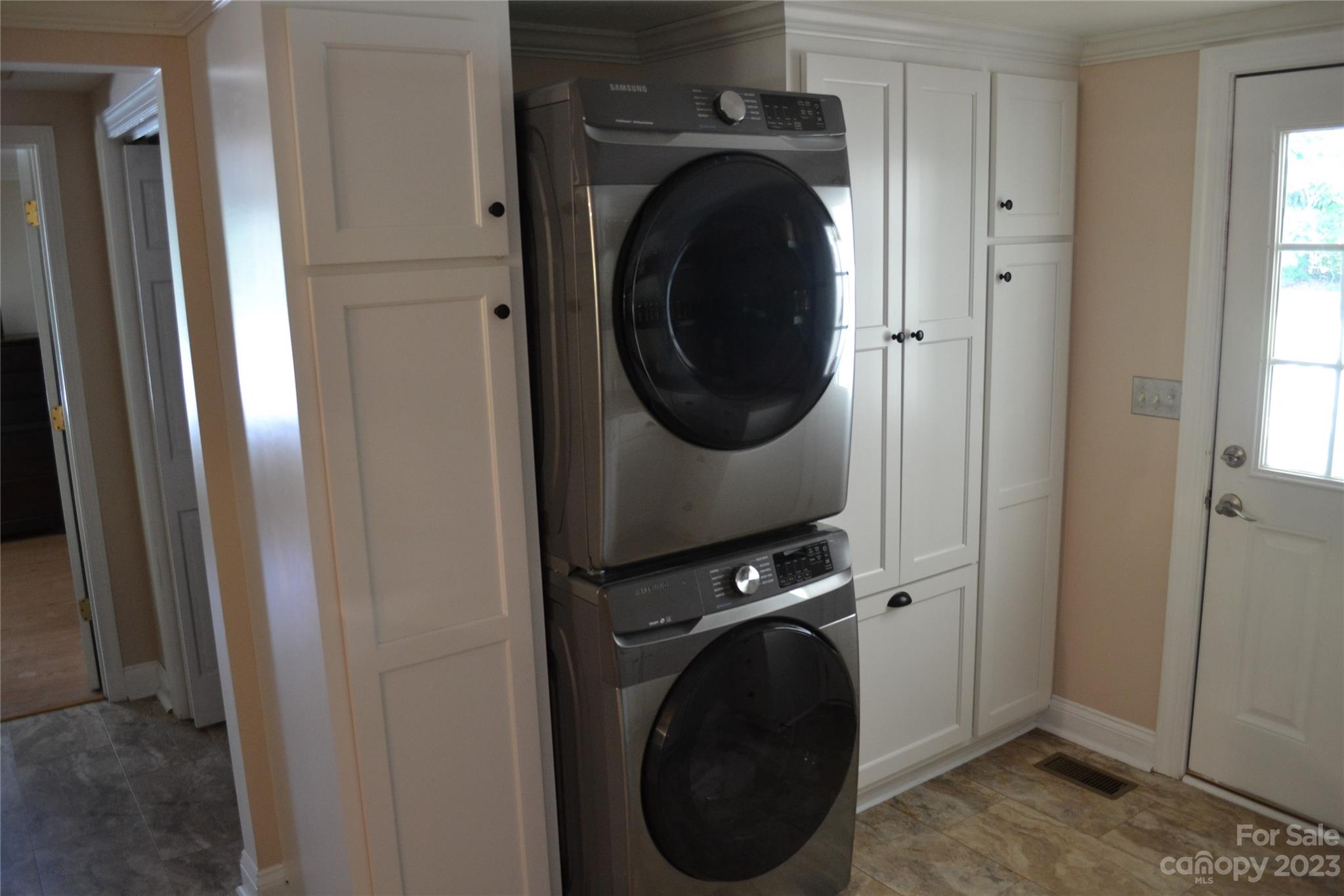 109 Tucker Street Locust, NC 28097 - Photo 10 of 13 a view of a hallway with washer and dryer