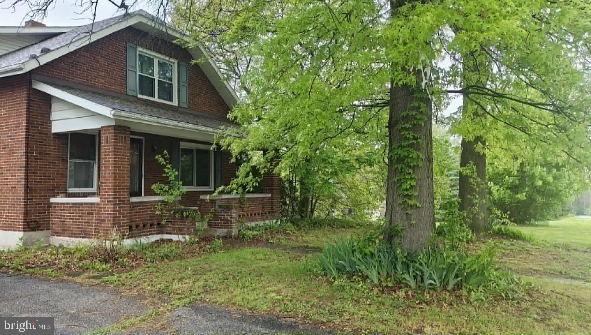 Charming brick home embraced by nature.