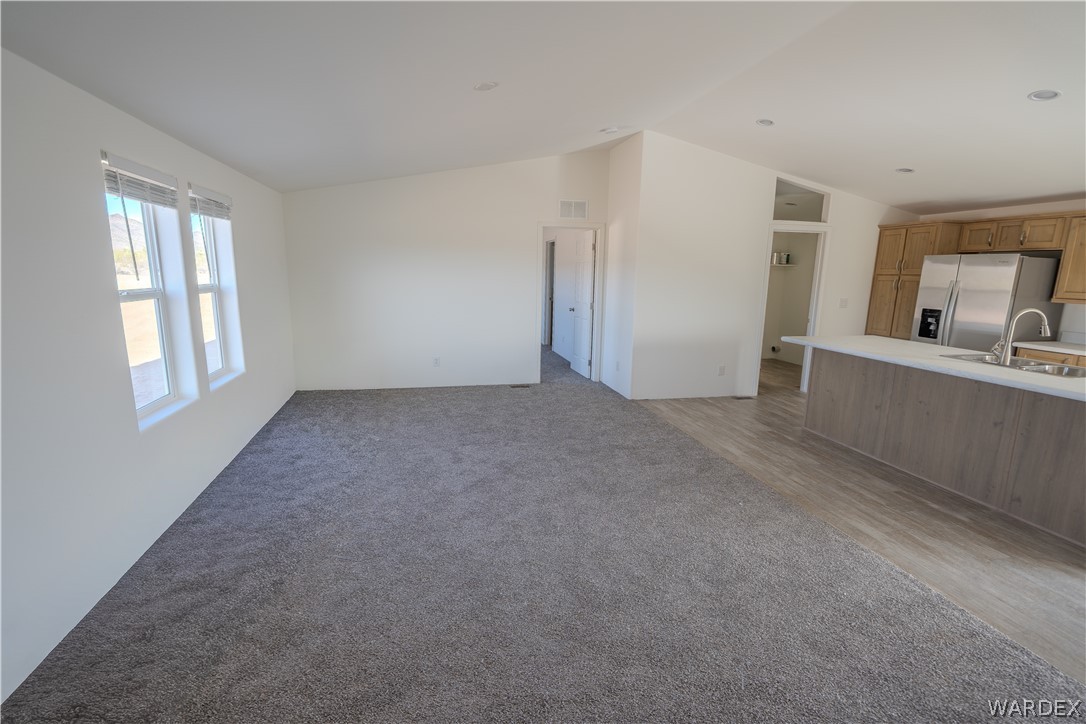 5746 Eden Road Golden Valley, AZ 86413 - Photo 10 of 27 a view of a big room with windows and cabinet