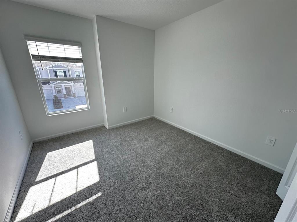 2713 Skyline Loop Kissimmee, FL 34758 - Photo 15 of 20 an empty room with windows and closet