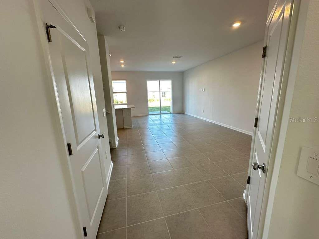 2713 Skyline Loop Kissimmee, FL 34758 - Photo 5 of 20 a view of a hallway with wooden floor and a bathroom