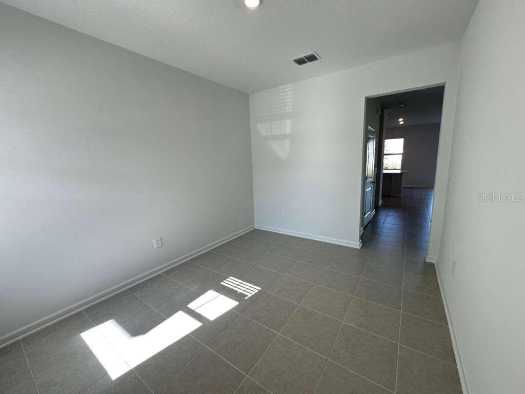 2713 Skyline Loop Kissimmee, FL 34758 - Photo 8 of 20 a view of an empty room and window