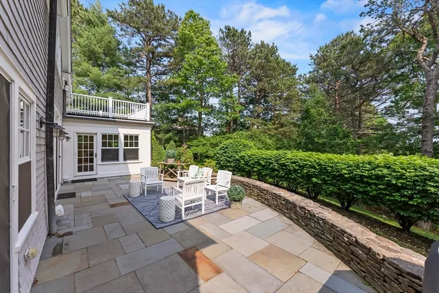 a view of a patio with table and chairs and potted plants