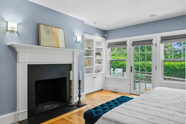 a bedroom with a bed and a fireplace