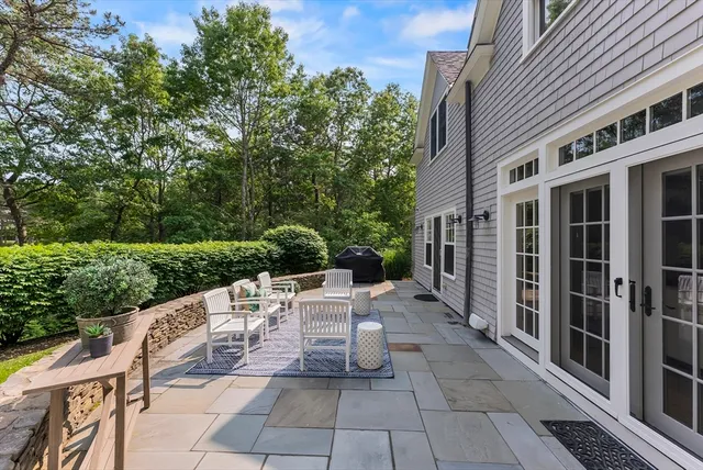 a view of a patio with a table and chairs and potted plants