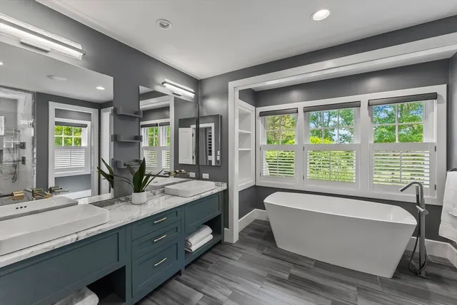 a spacious bathroom with a large tub and sink