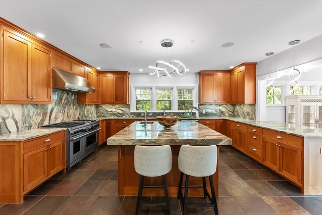 a large kitchen with a table and chairs