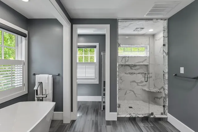 a bathroom with a bathtub and a shower