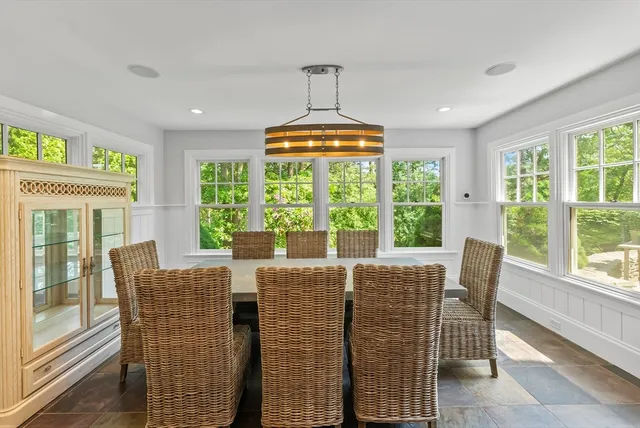 a dining room with furniture a chandelier and wooden floor