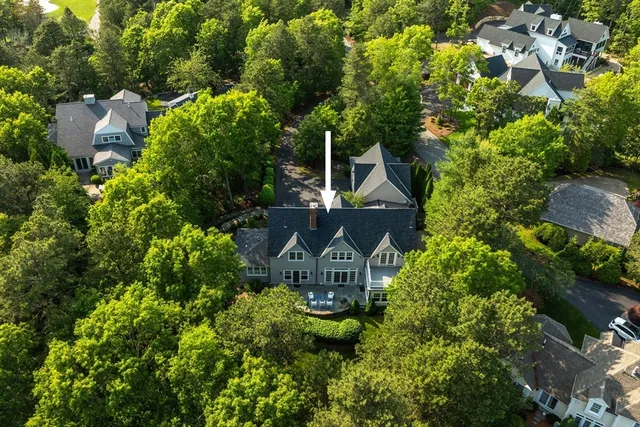 an aerial view of a house with swimming pool and garden