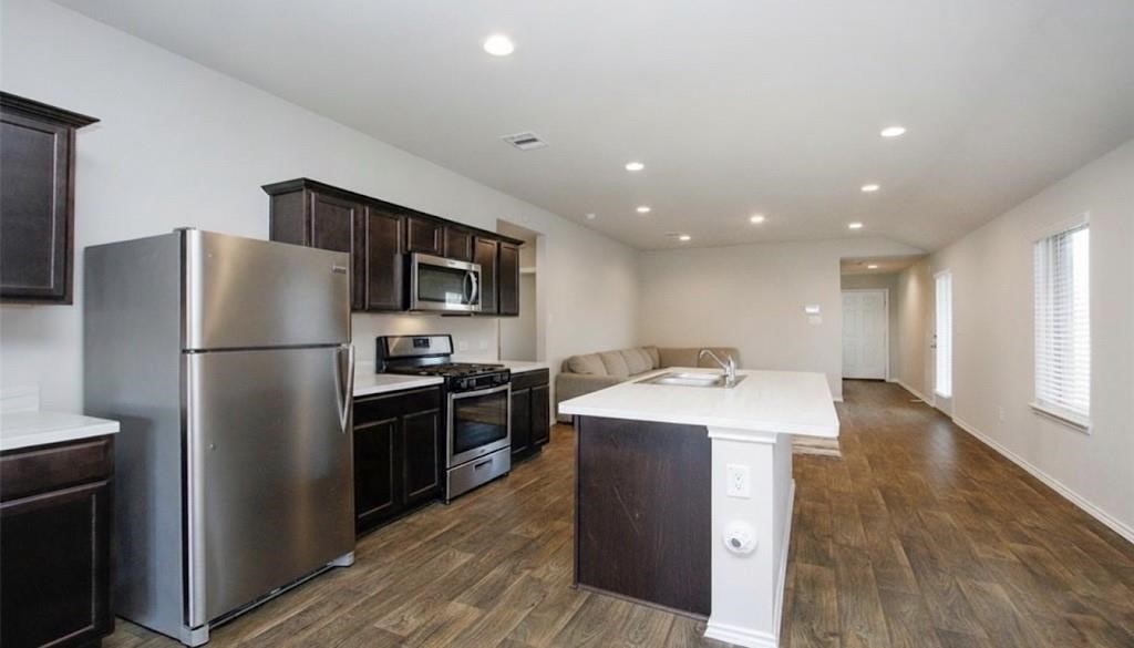 2354 Otter Falls Drive Spring, TX 77373 - Photo 5 of 9 a kitchen with a refrigerator and a sink