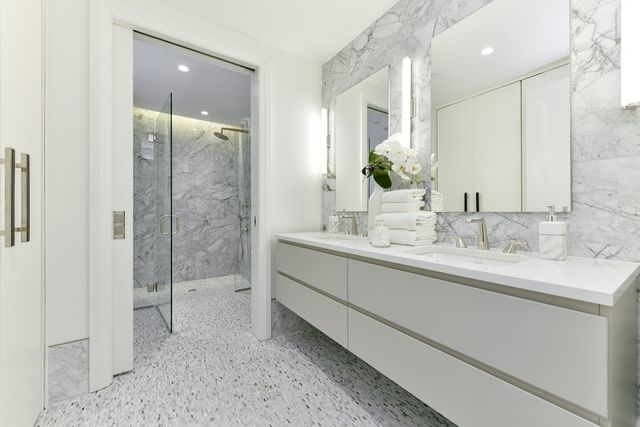 a large white bed in a hotel room next to a window