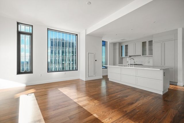 a view of a kitchen with granite countertop cabinets and wooden floor