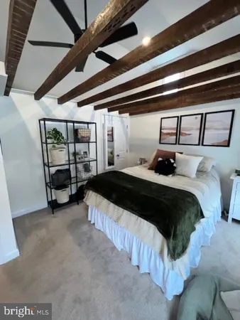 a room with wooden floor pool table and windows