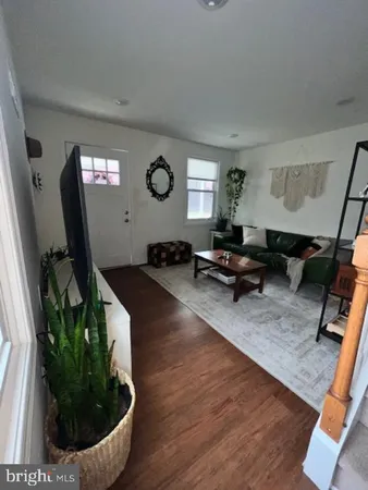 a kitchen with stainless steel appliances a dining table chairs refrigerator and cabinets