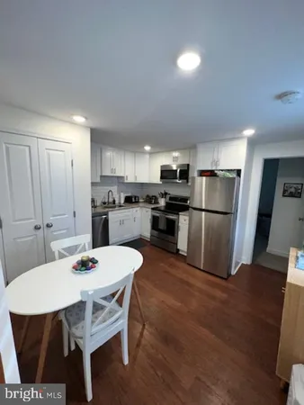 a living room with furniture a table and a potted plant