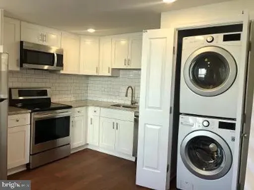 a kitchen with a washer and a sink