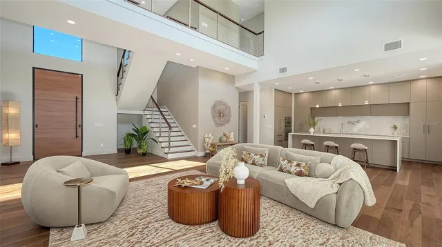 a kitchen with kitchen island a wooden floor and chairs