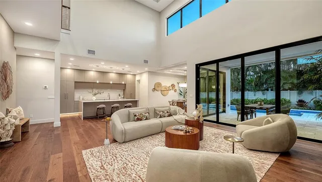 a view of kitchen with granite countertop a sink a counter top space and living room
