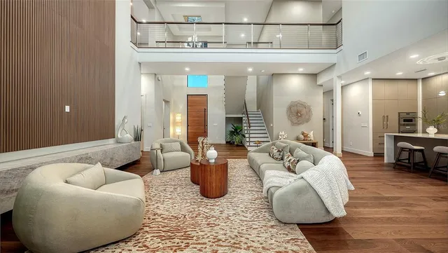 a kitchen with kitchen island granite countertop a sink and a refrigerator