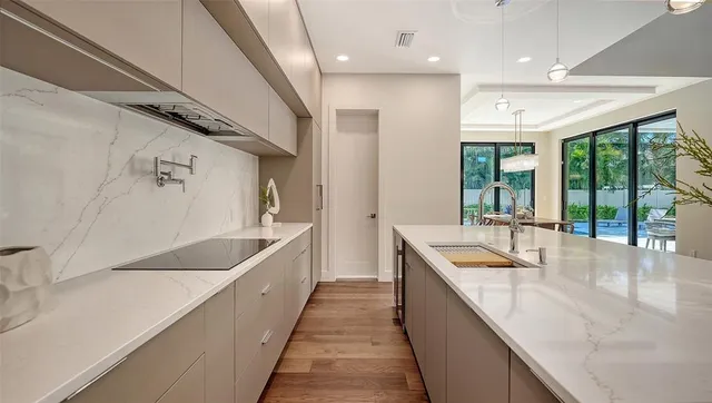 a view of a patio with a table chairs and a floor to ceiling window