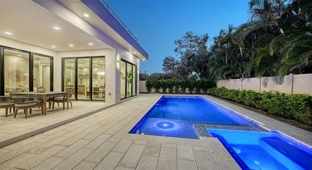 a living room with furniture and a view of kitchen