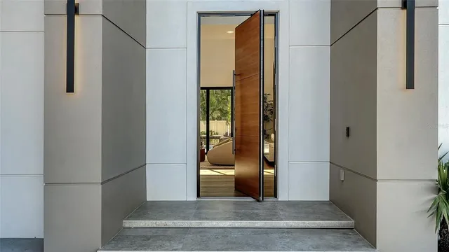 a living room with furniture and a floor to ceiling window