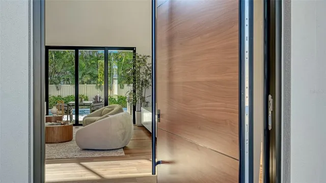 a living room with furniture and a floor to ceiling window