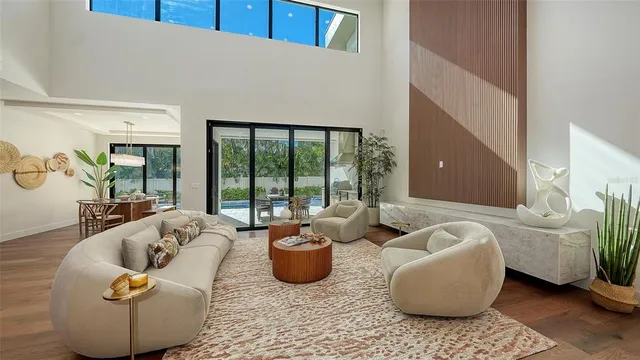 a living room with furniture and a large window with outer view