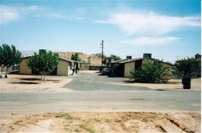 20287 Otoe Road Apple Valley, CA 92307 - Photo 1 of 1 a street view with large trees