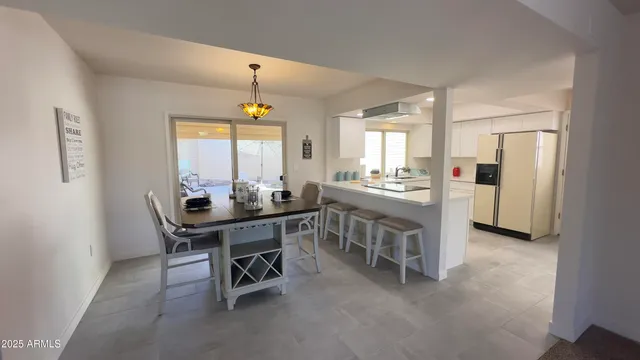 a view of a dining room with furniture and window
