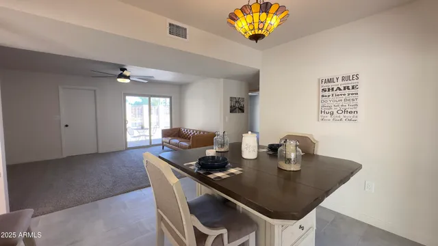 a living room with furniture a window and a dining table