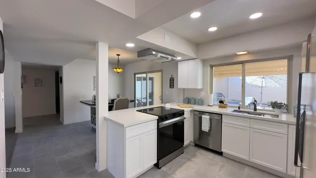a kitchen with a table chairs and a refrigerator