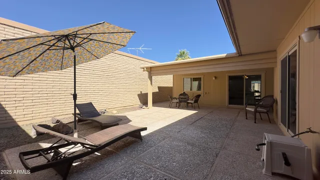 a view of a chairs and table in patio
