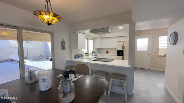 a large kitchen with a table and chairs