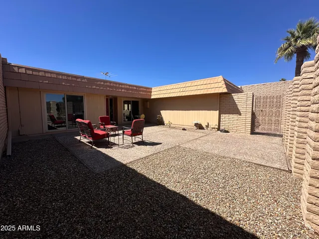 a view of a porch with furniture and a yard