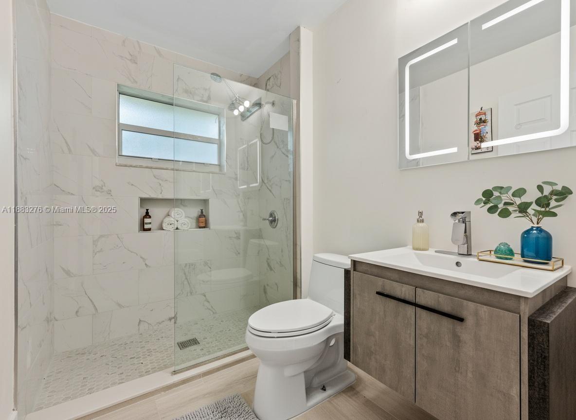 14401 Southwest 23rd Street Davie, FL 33325 - Photo 11 of 56 a bathroom with a sink a toilet and shower