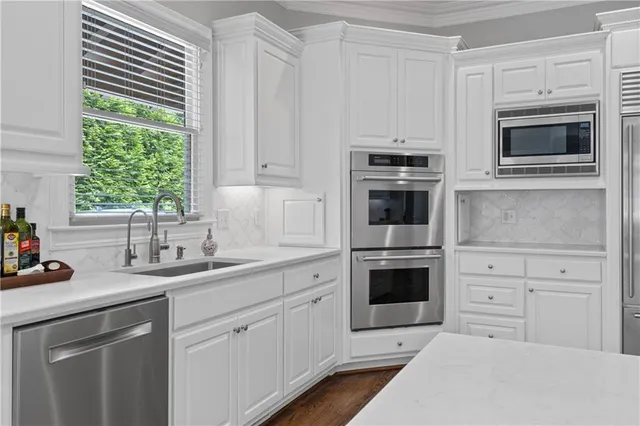 a large bathroom with a double vanity sink a mirror and a bathtub
