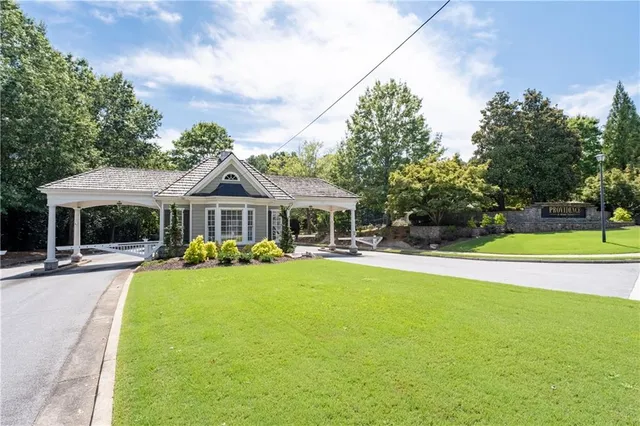 front view of a brick house with a large windows and a flower plants in front of main door