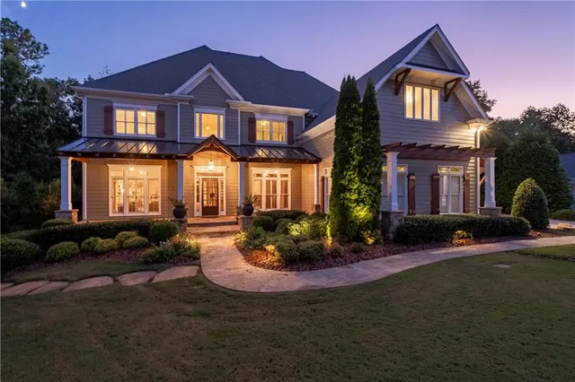 a backyard of a house with table and chairs