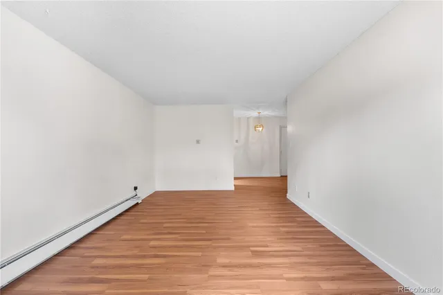 a view of an empty room and wooden floor