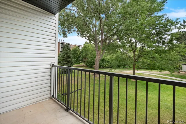 a view of a balcony with yard