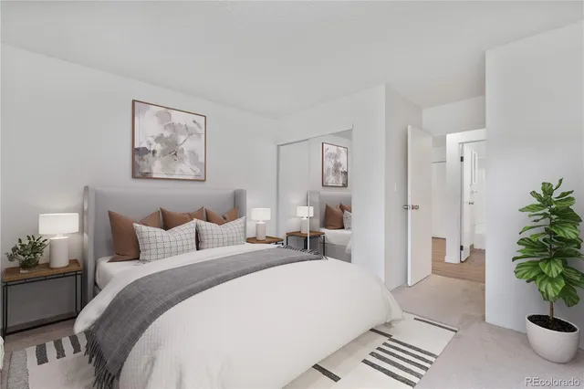 a bedroom with furniture and a potted plant