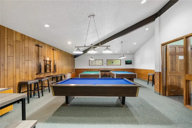 a room with pool table table tennis table and windows