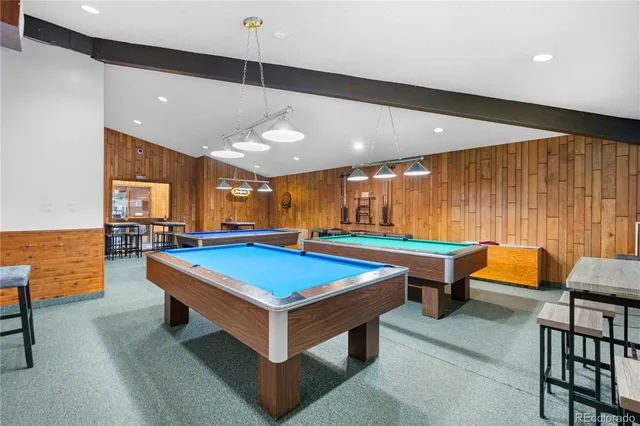 a view of a workspace with furniture and a bookshelf
