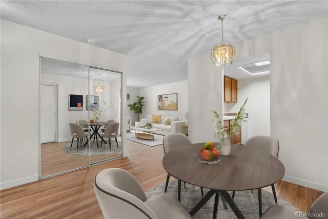 a view of a dining room with furniture wooden floor and a chandelier