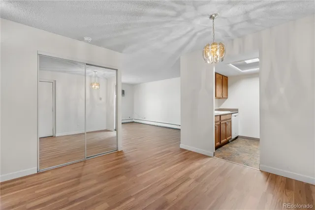 a view of a room with wooden floor and window