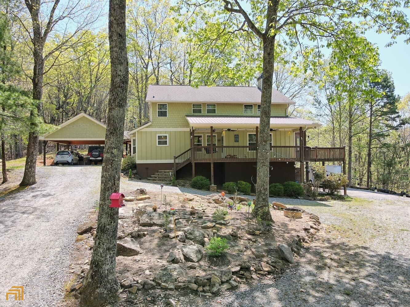 a front view of a house with a yard covered with snow
