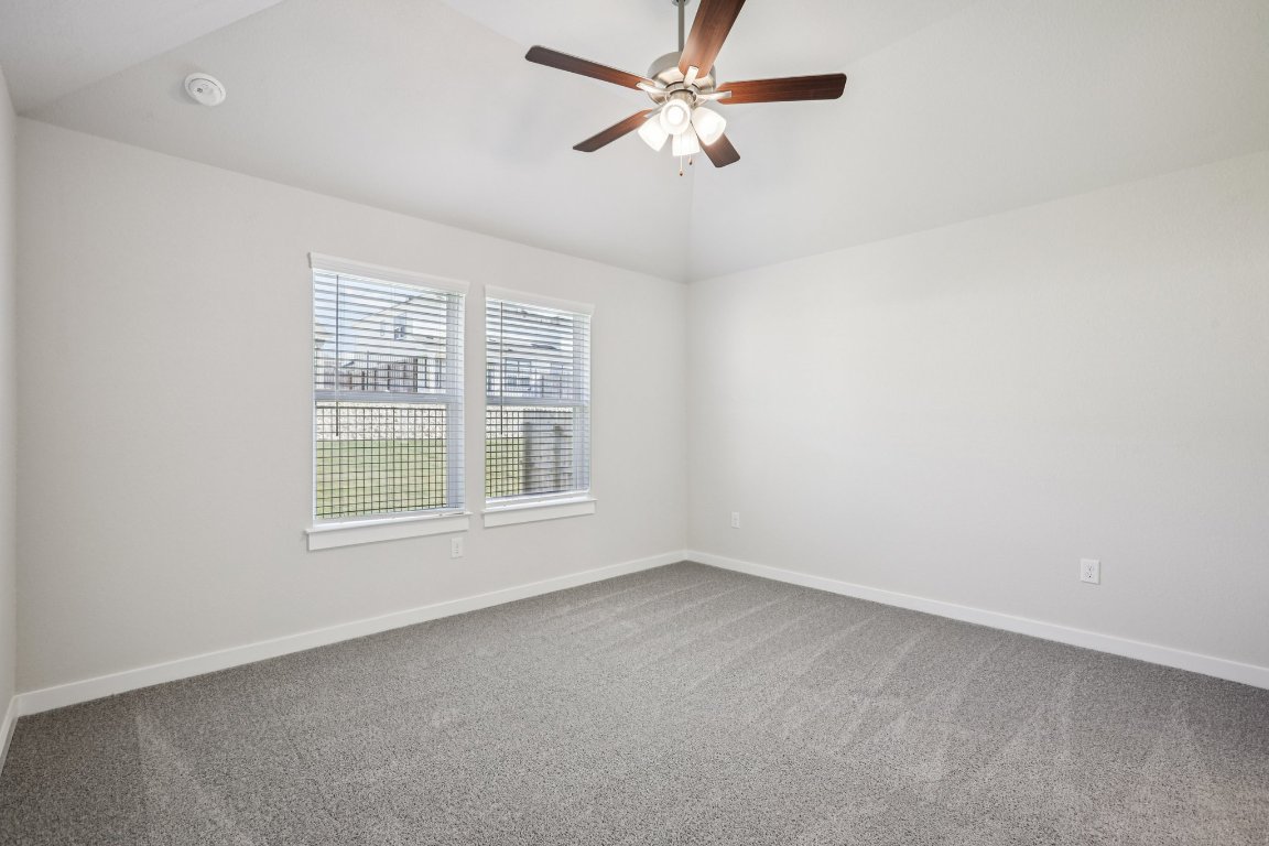 2304 Delano Drive Leander, TX 78641 - Photo 17 of 31 an empty room with a window and a fan