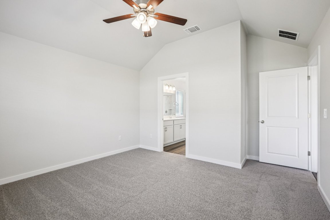 2304 Delano Drive Leander, TX 78641 - Photo 18 of 31 an empty room with a chandelier fan and closet area